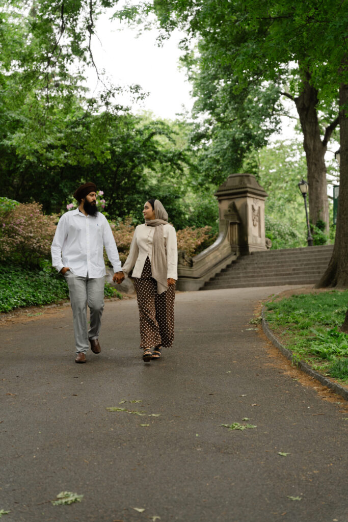 Couple walking through Central Park during a romantic photoshoot in New York City